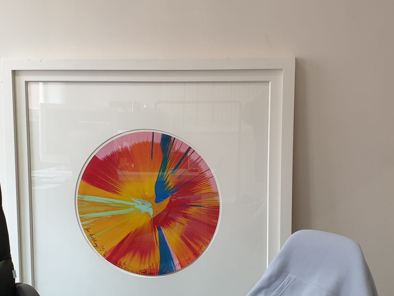 The personalised Damien Hirst spin painting, framed in white