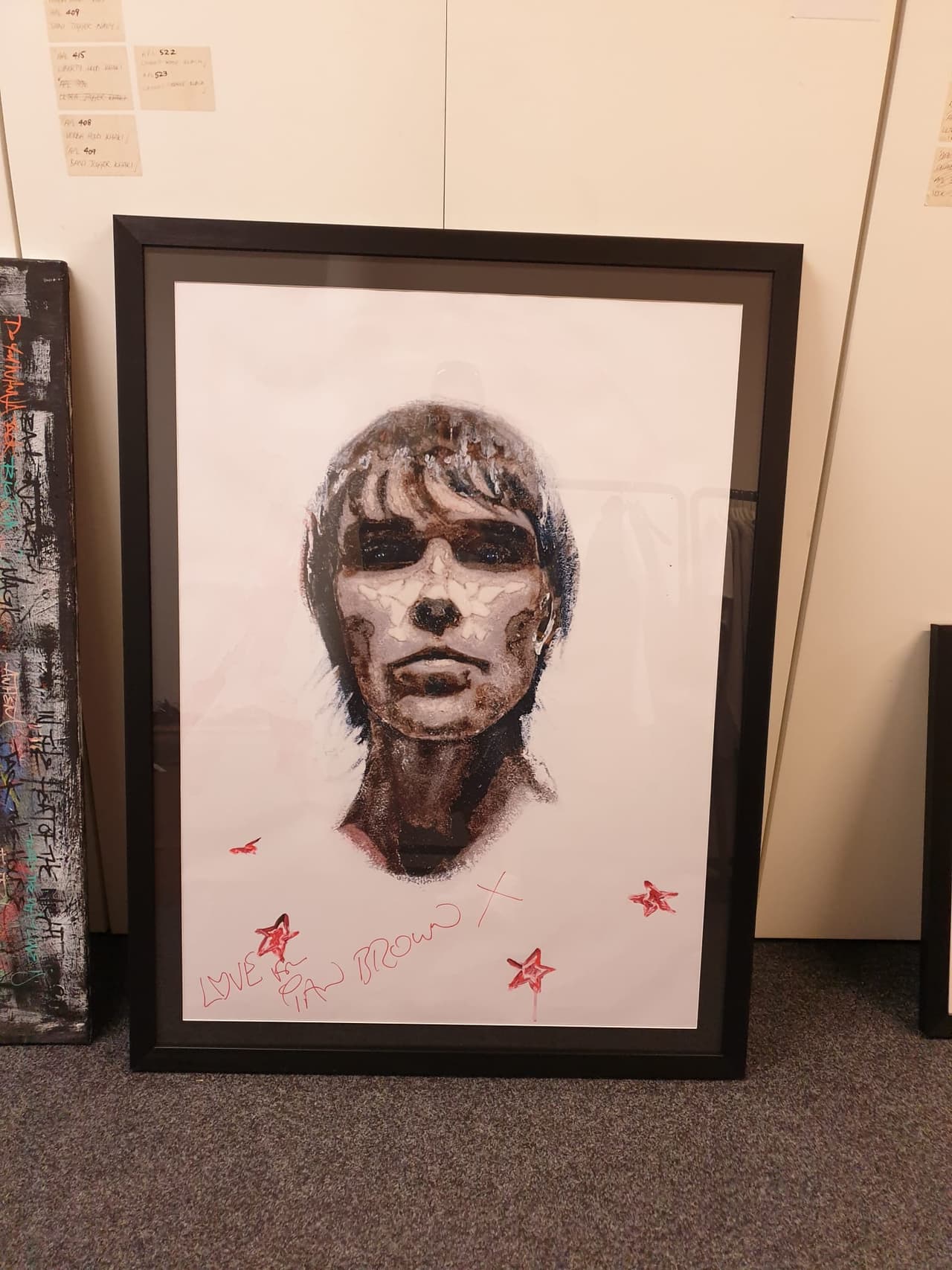A framed portrait drawing, signed in red with stars