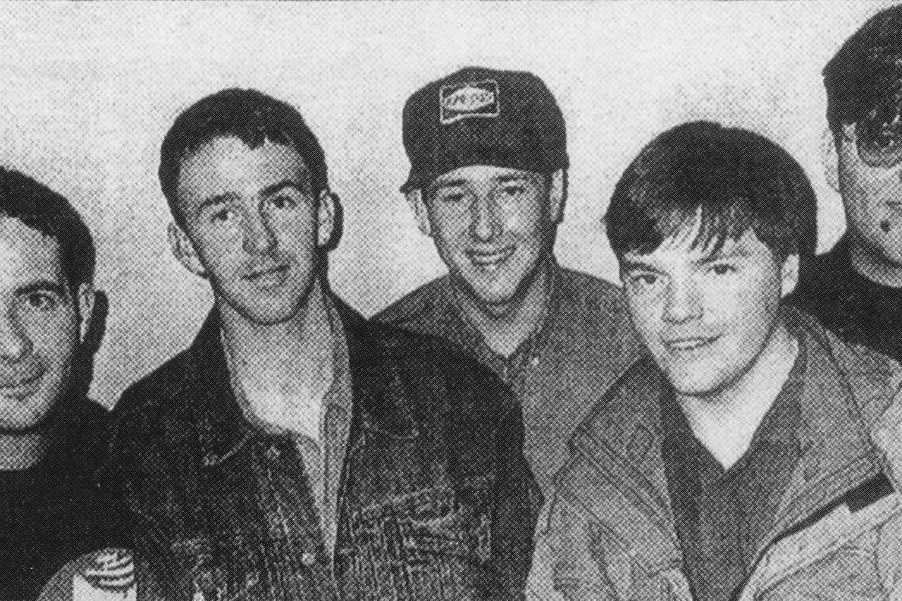 Black and white press photo of a group of young men